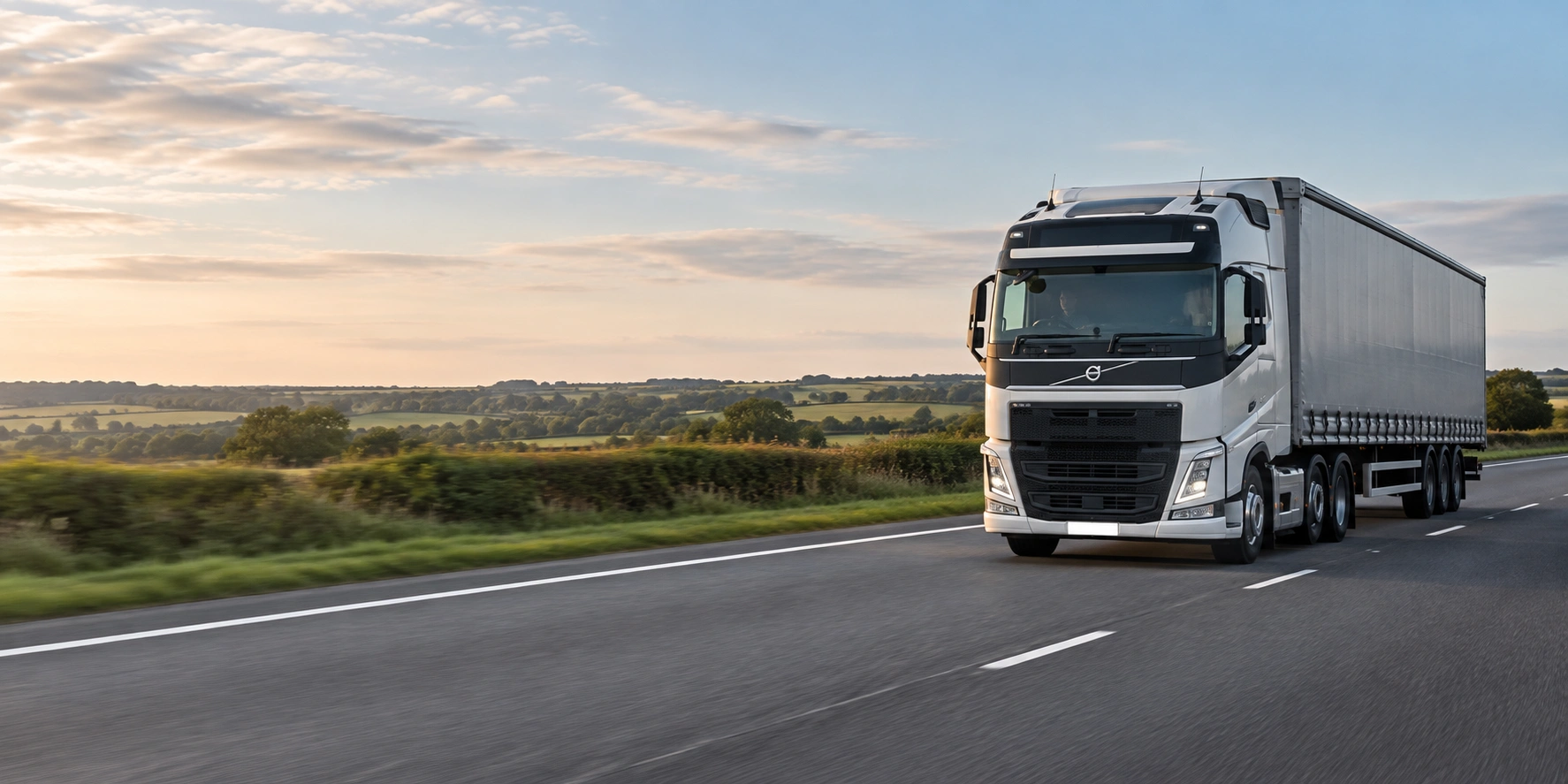 A lorry on a British road at dusk