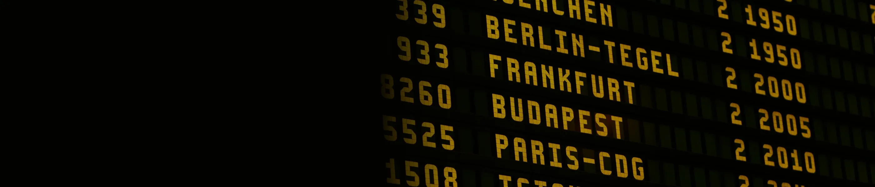 An airport departures board in a terminal